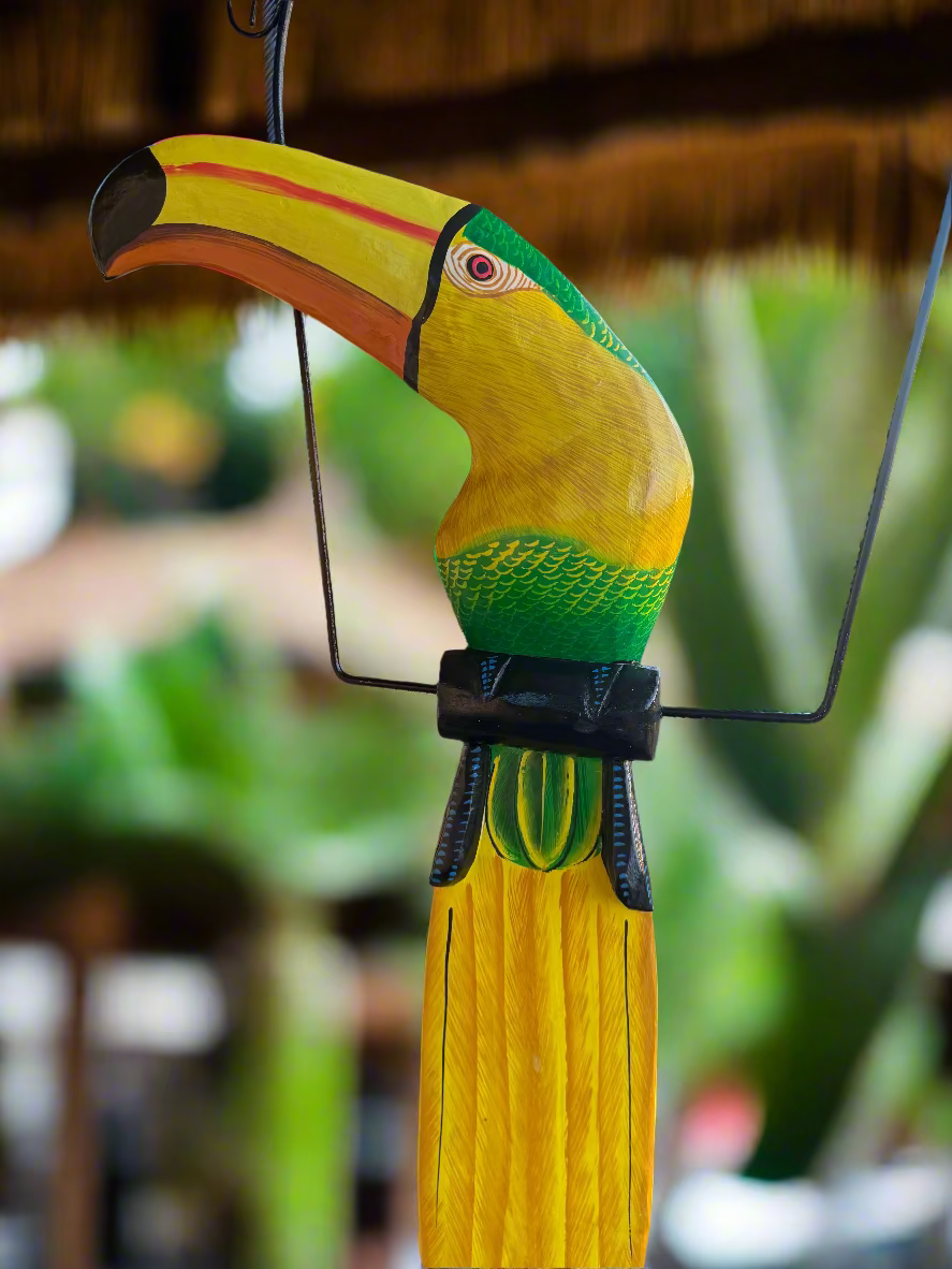Green toucan hanging on a perch