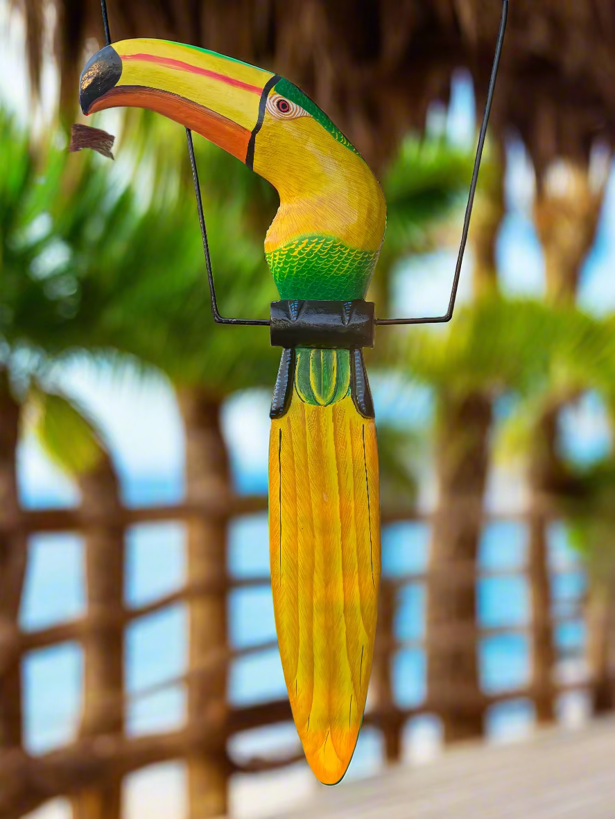 Hanging green decorative wooden toucan on a perch.
