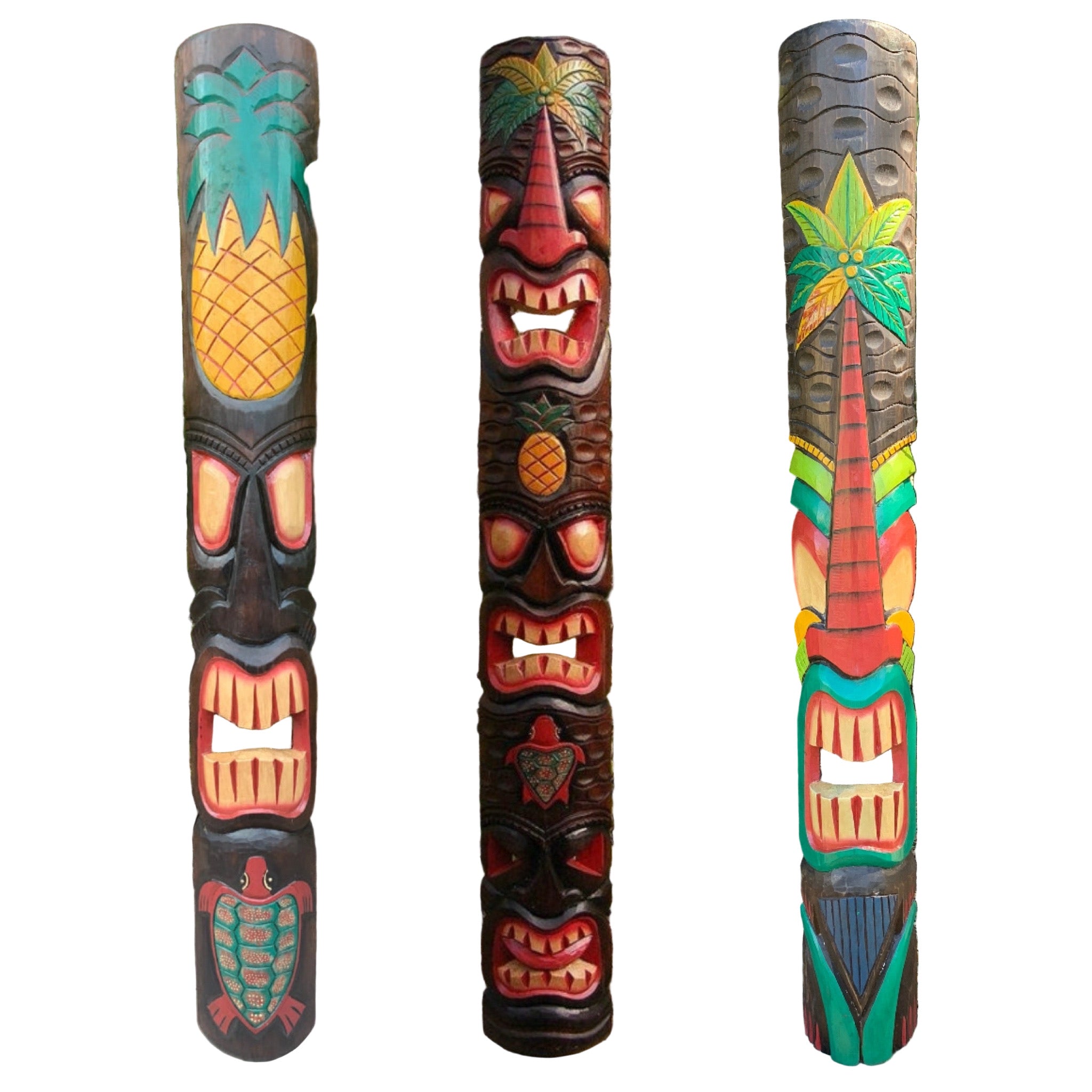 Three colorful tiki statues with tropical designs against a natural background.