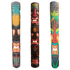 Three colorful tiki statues with tropical designs against a natural background.