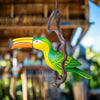 Decorative  toucan hanging ornament on a branch 