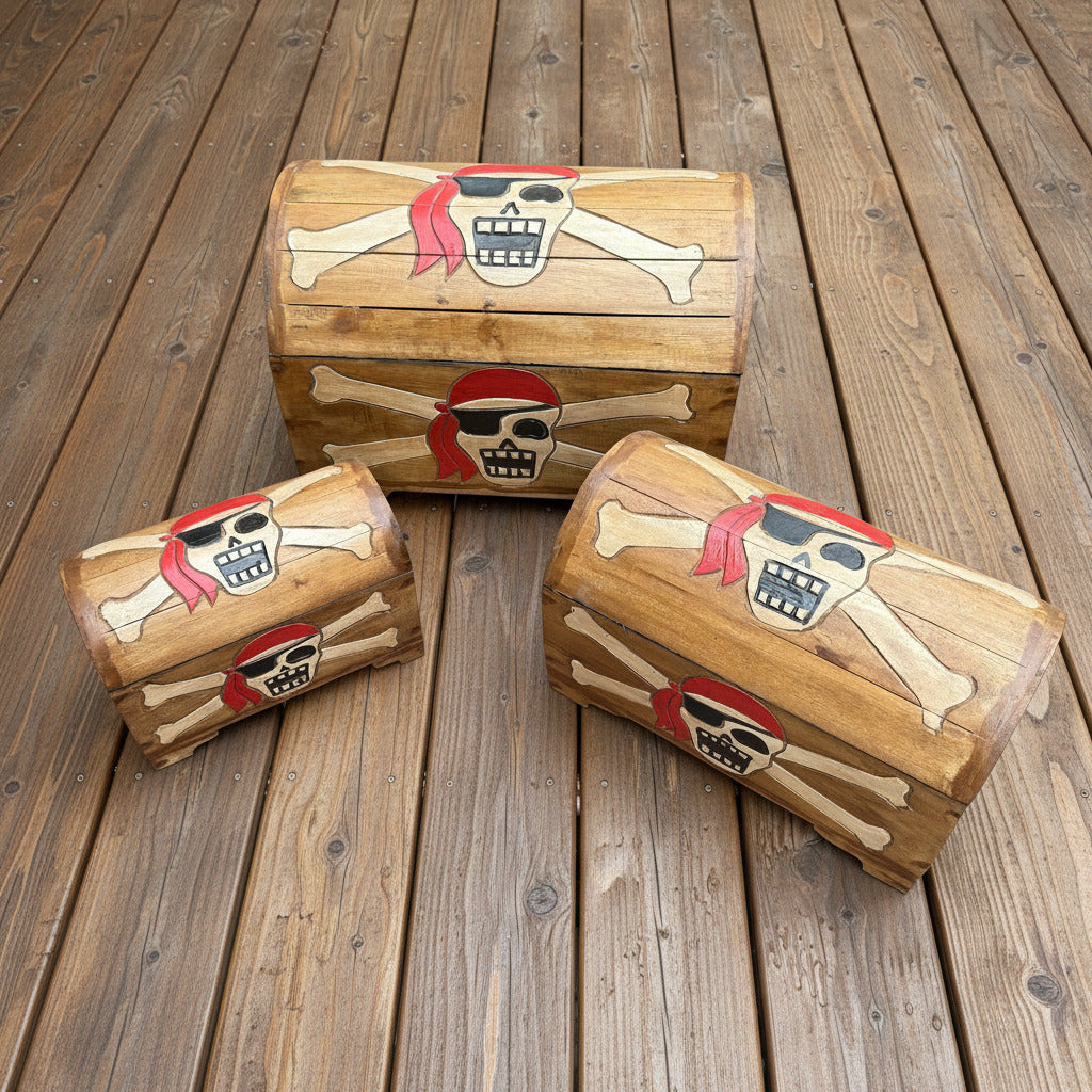 Three wooden treasure chests with pirate-themed designs on a wooden surface.