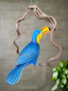 Blue-and-yellow macaw perched on a twisted wooden ring.