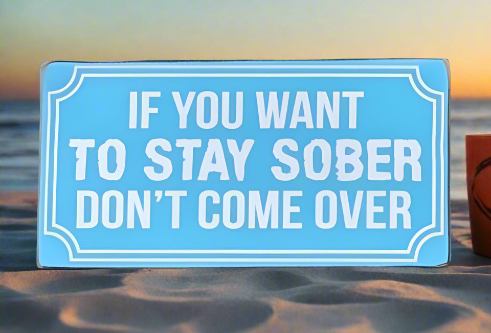 Blue beach sign reading: If you want to stay sober, don't come over.