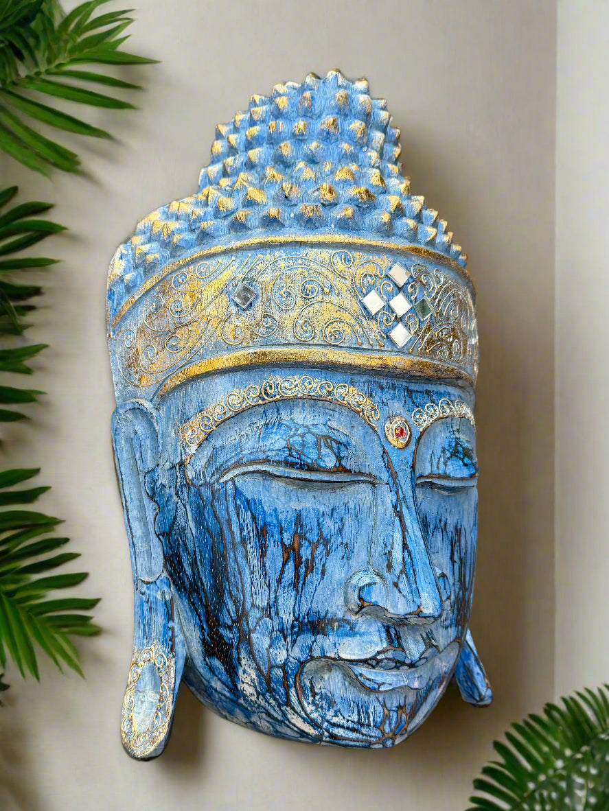 Blue Buddha head sculpture with ornate gold crown and closed eyes