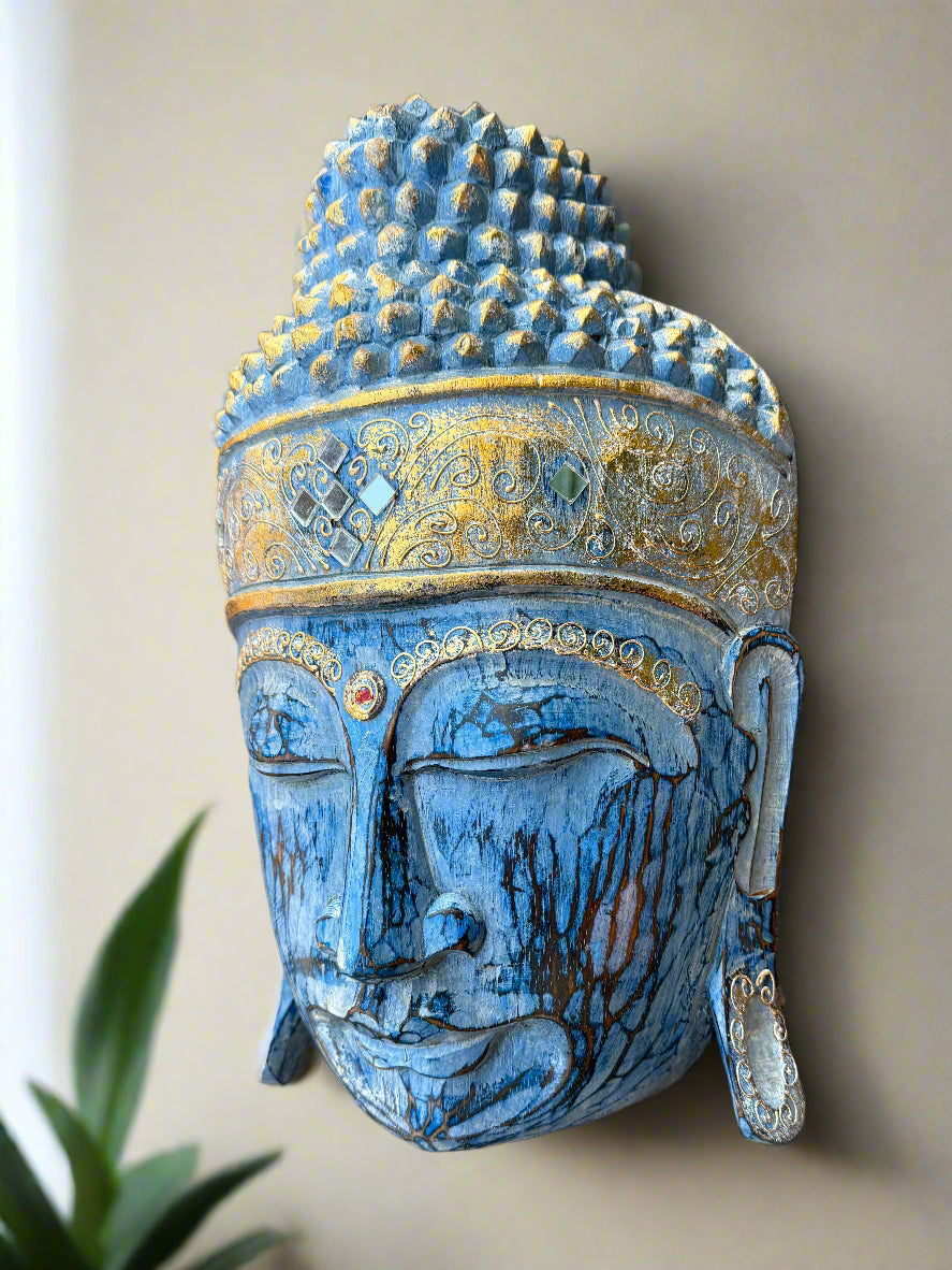 Blue Buddha head sculpture with gold decorative band and ornate patterns.