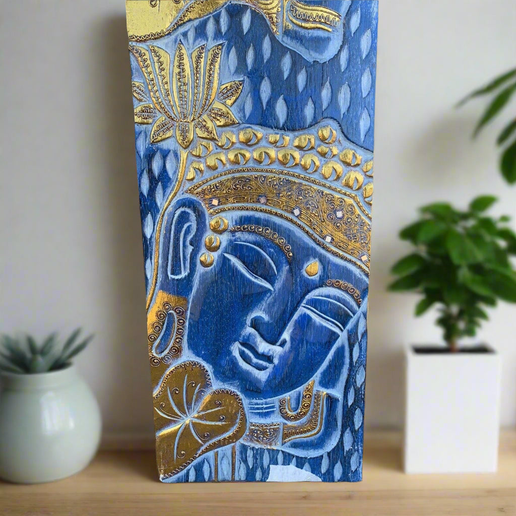 Blue Buddha head with gold ornate detailing on decorative panel