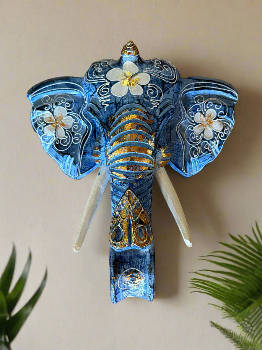 Blue decorative elephant sculpture with white floral patterns and gold accents