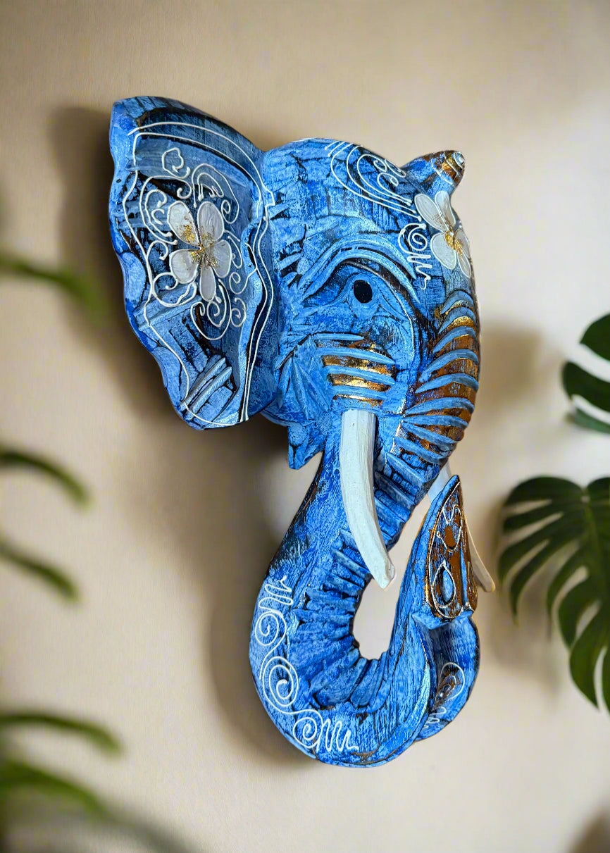Blue elephant wall sculpture with white floral patterns and gold accents