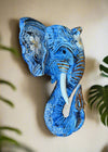Blue elephant wall sculpture with white floral patterns and gold accents