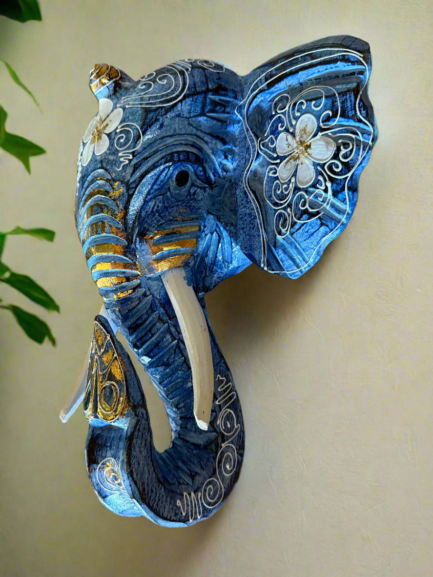 Blue ornate elephant sculpture with white floral patterns and gold accents