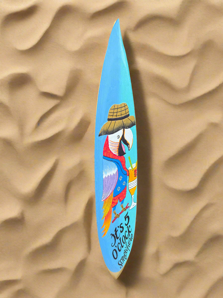 Blue surfboard featuring a colorful parrot illustration on sand
