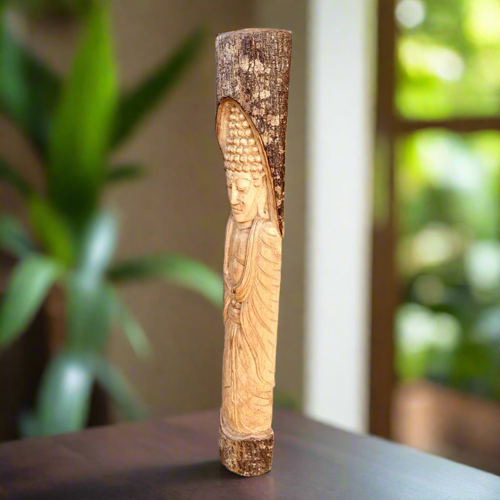 carved Buddha statue on a wooden post indoors
