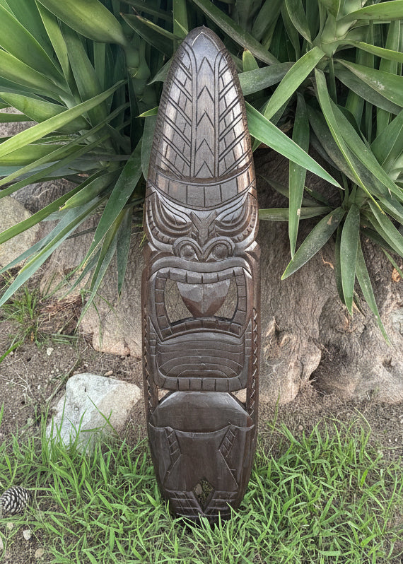 A surfboard carved into a tiki