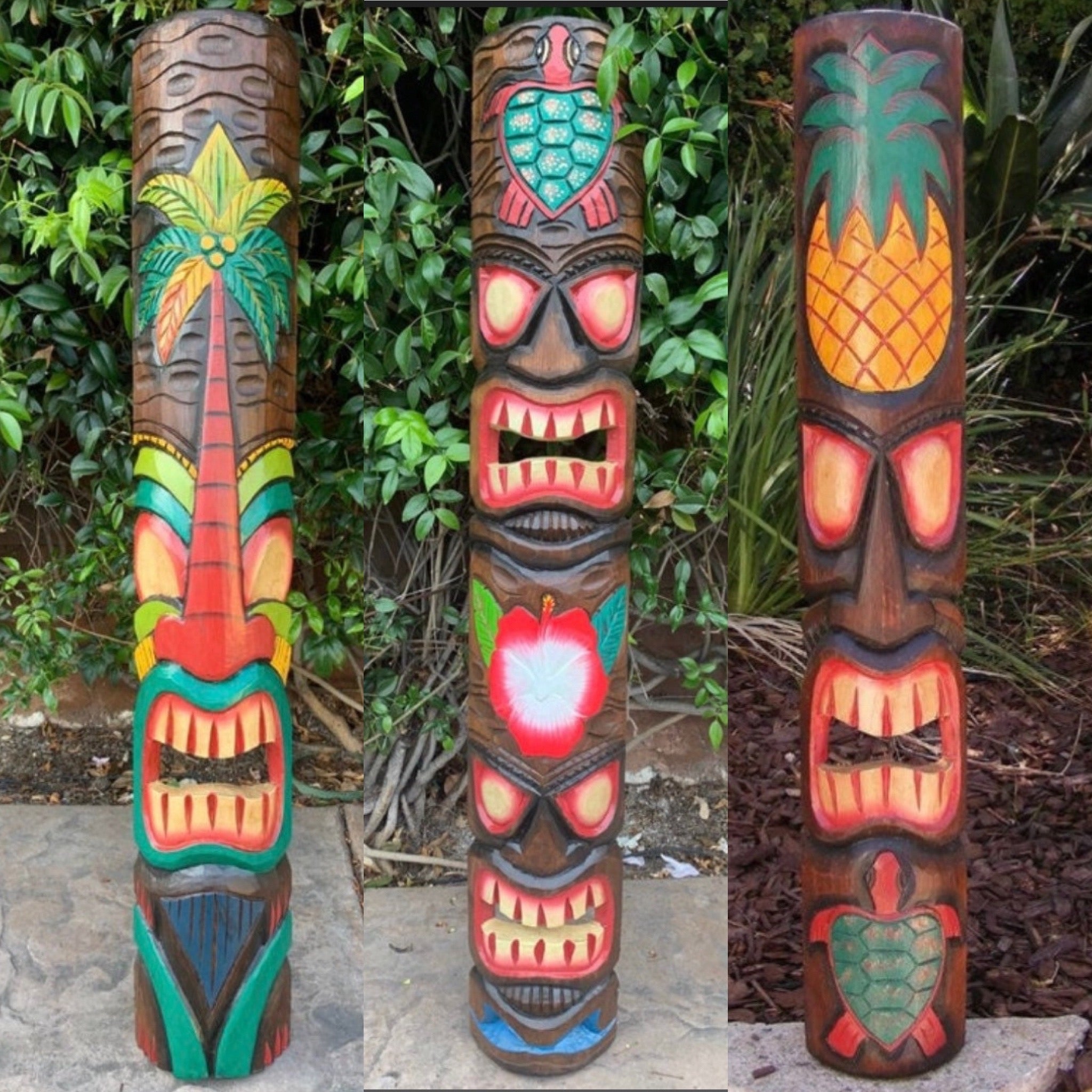 Three colorful wooden tiki totem poles with carved faces in a garden.