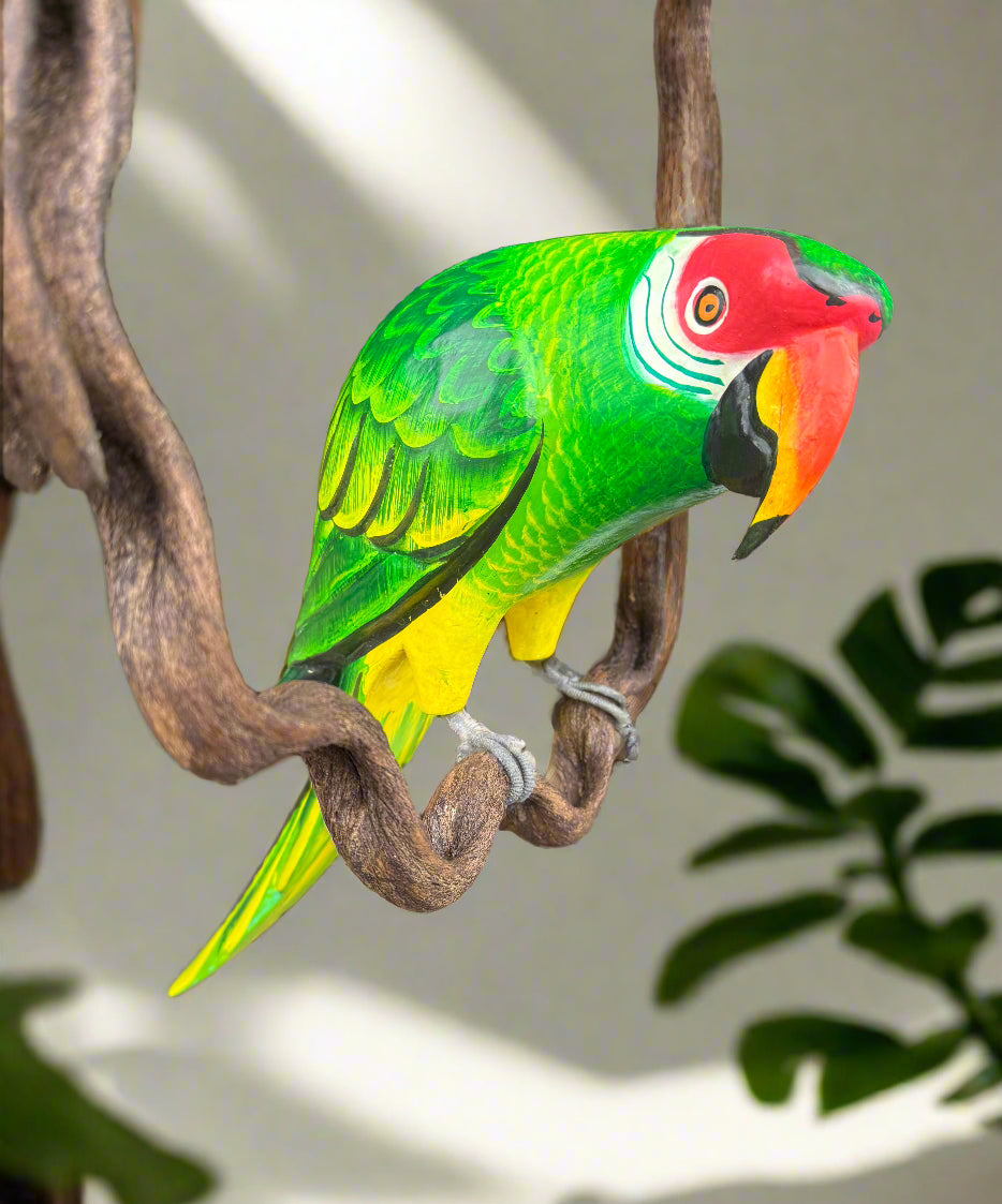 colorful-green-parrot-sculpture-with-red-head-perched-on-branch