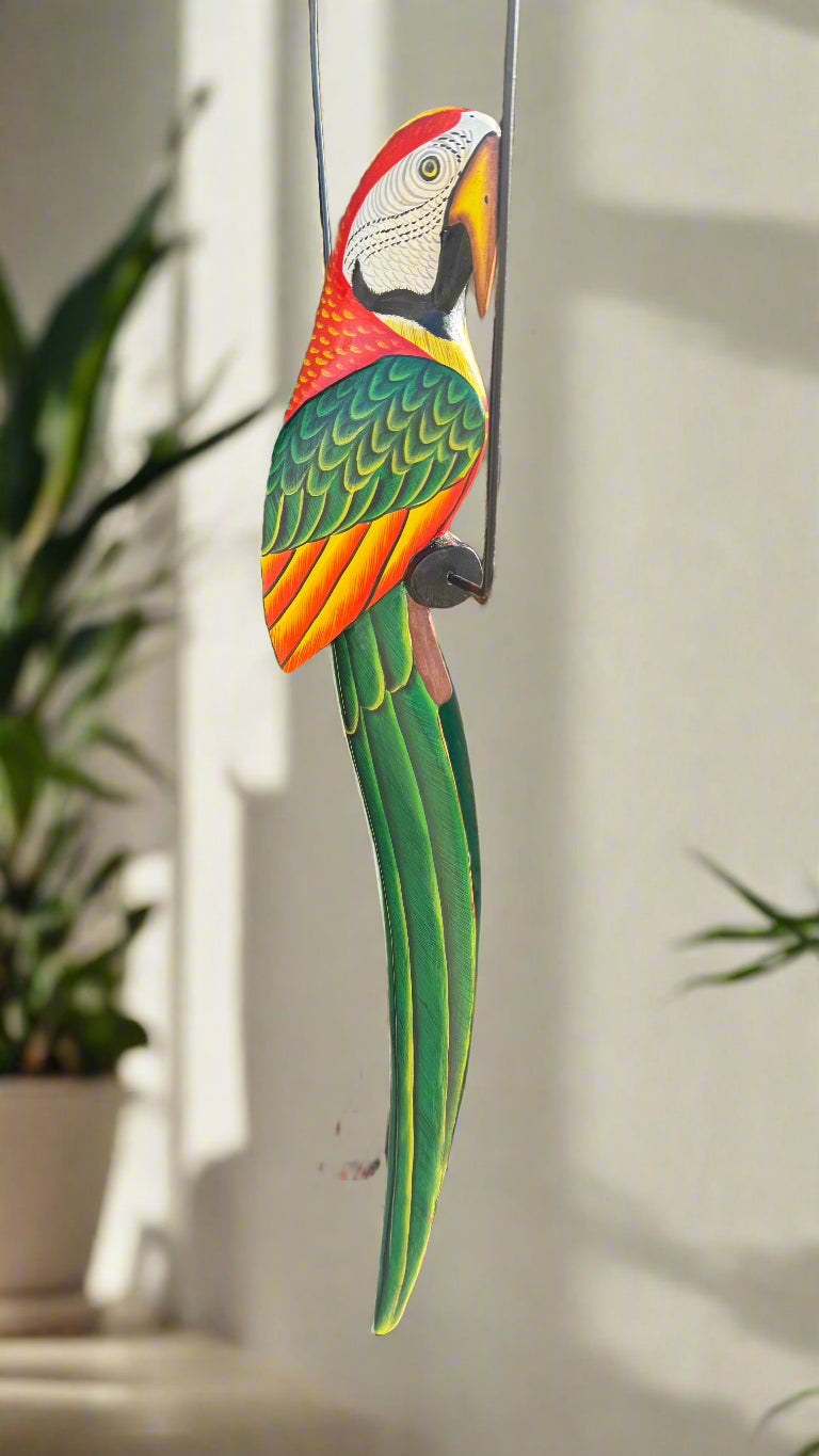colorful carved wooden macaw parrot decoration hanging from a wire