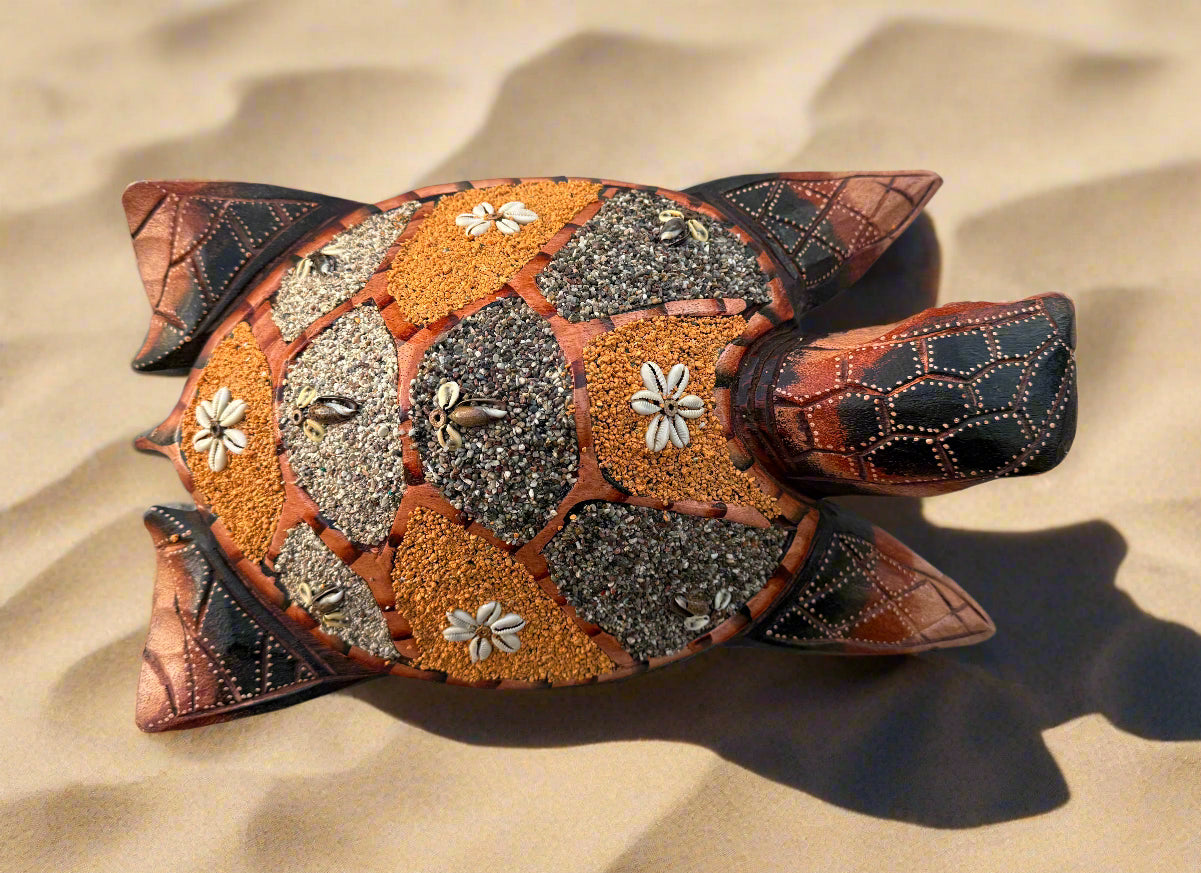 decorative mosaic turtle figurine with pebble shell on sand