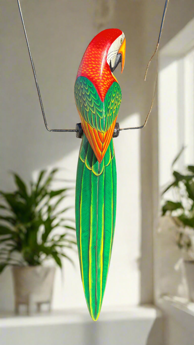 Colorful parrot sculpture hanging on a wire indoors