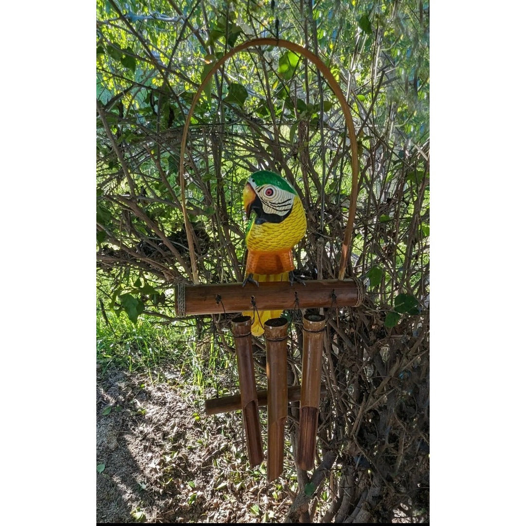 Colorful parrot statue perched on a wooden bamboo bird feeder outdoors