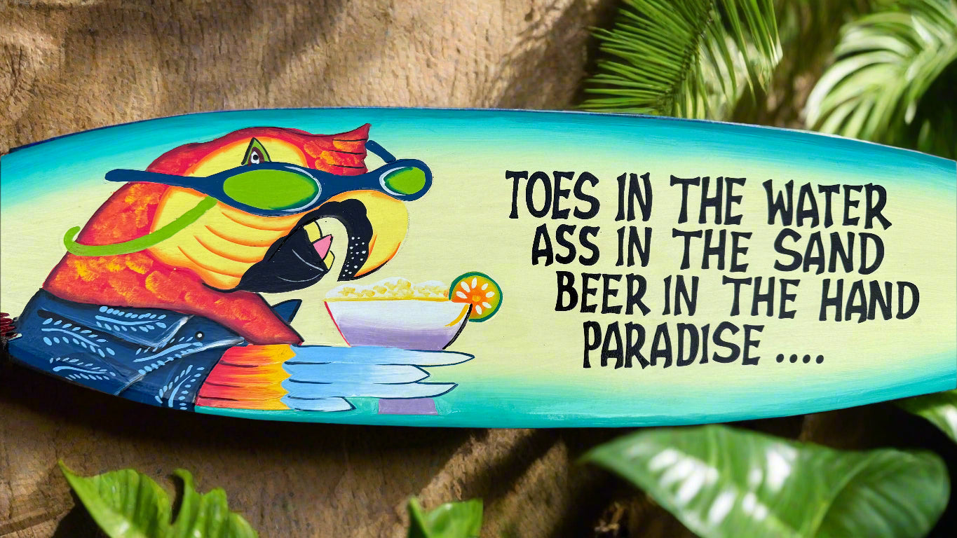 Vibrant surfboard graphic featuring a cartoon character wearing sunglasses and a beachy quote about paradise