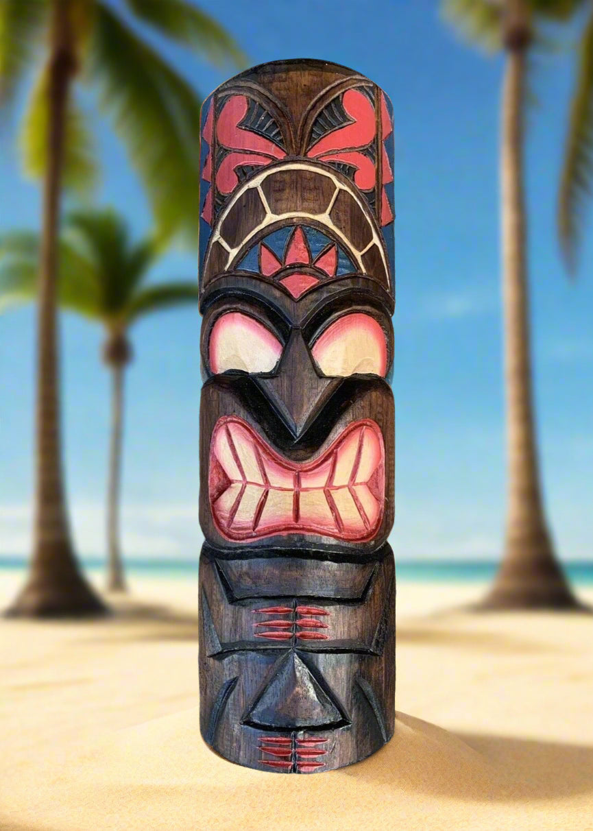 Colorful tiki totem carved from wood on a sandy beach with palm trees in the background