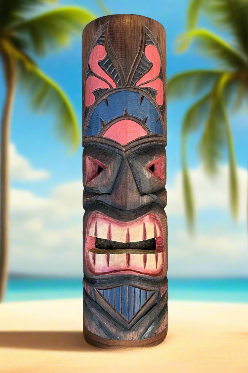 Colorful carved tiki totem pole on a tropical beach with palm trees.