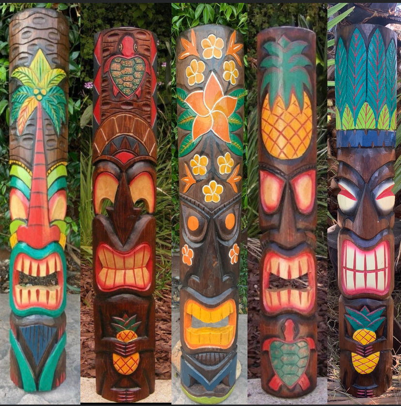 Five colorful tiki totem poles painted with tropical flowers and palm leaf designs