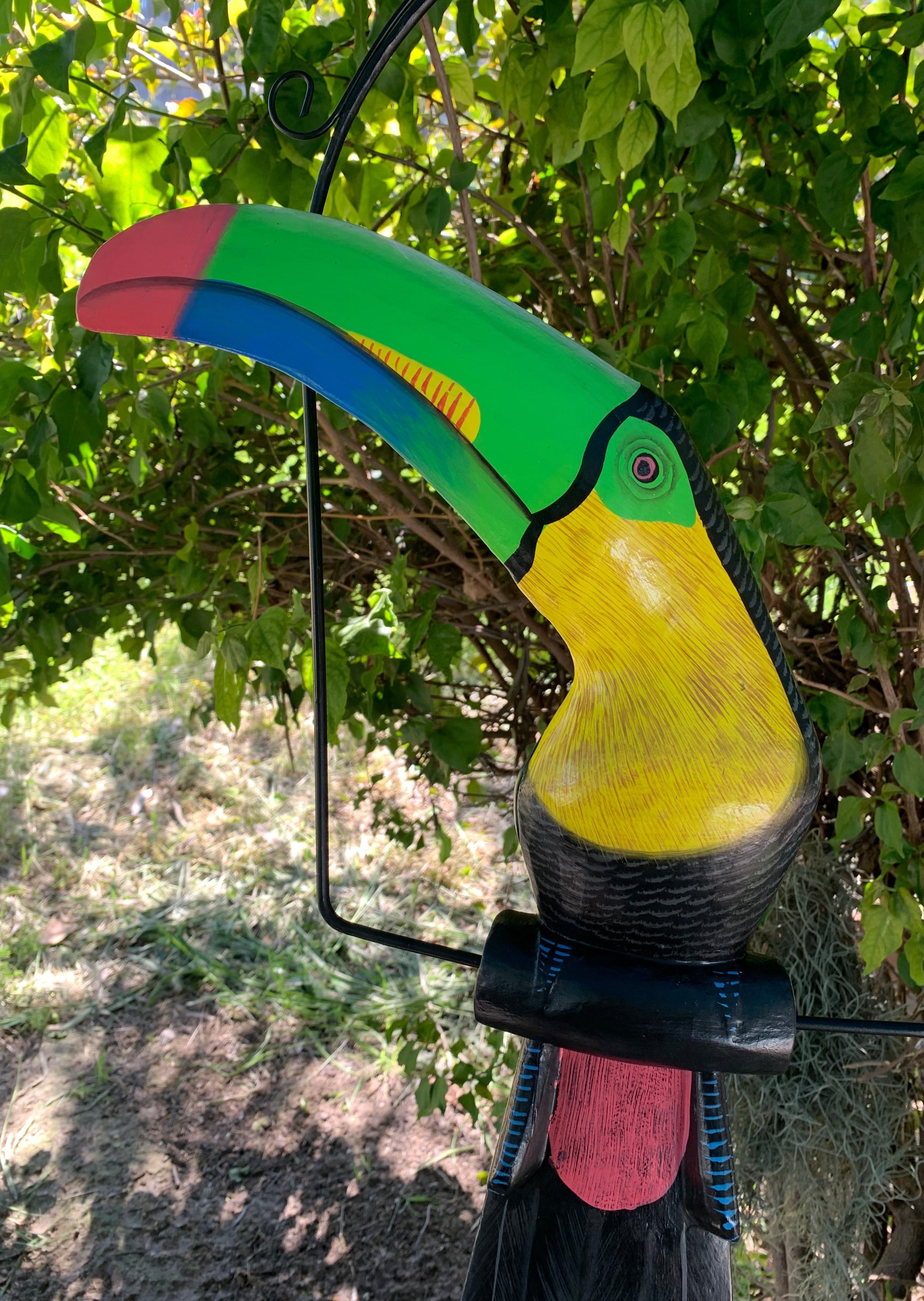 Colorful toucan garden statue with a green beak and yellow chest