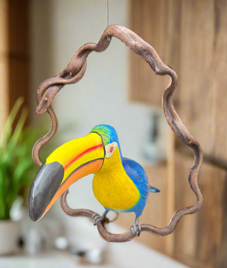 Colorful toucan hanging ornament with a twisted metal frame