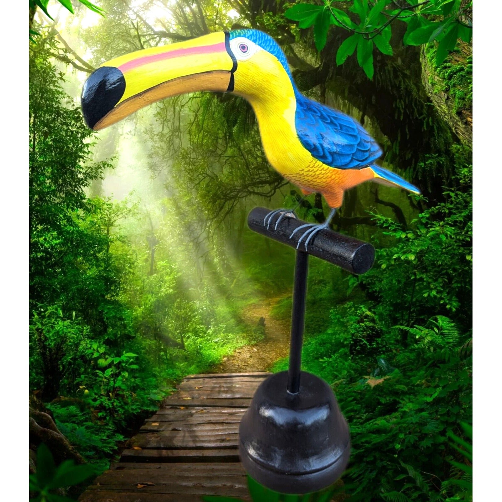 Colorful toucan sculpture perched on a stand in a lush jungle setting