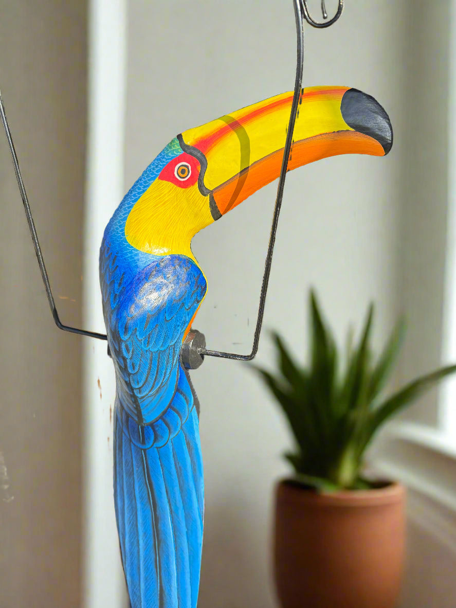 Colorful toucan wall sculpture with blue wings and yellow beak
