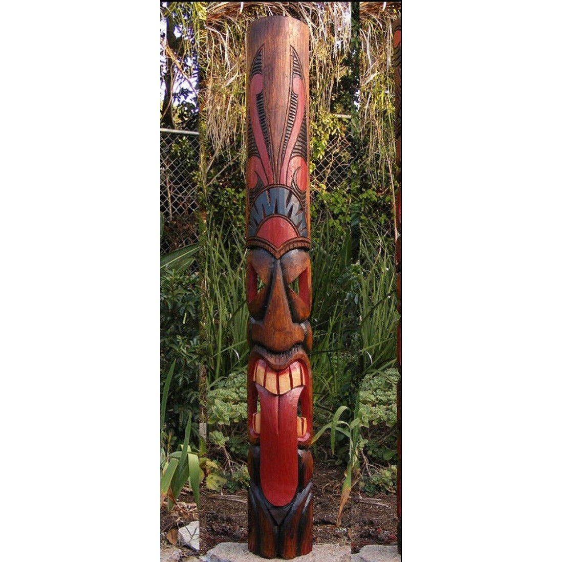 Colorful wooden totem pole carving with tribal patterns in a garden