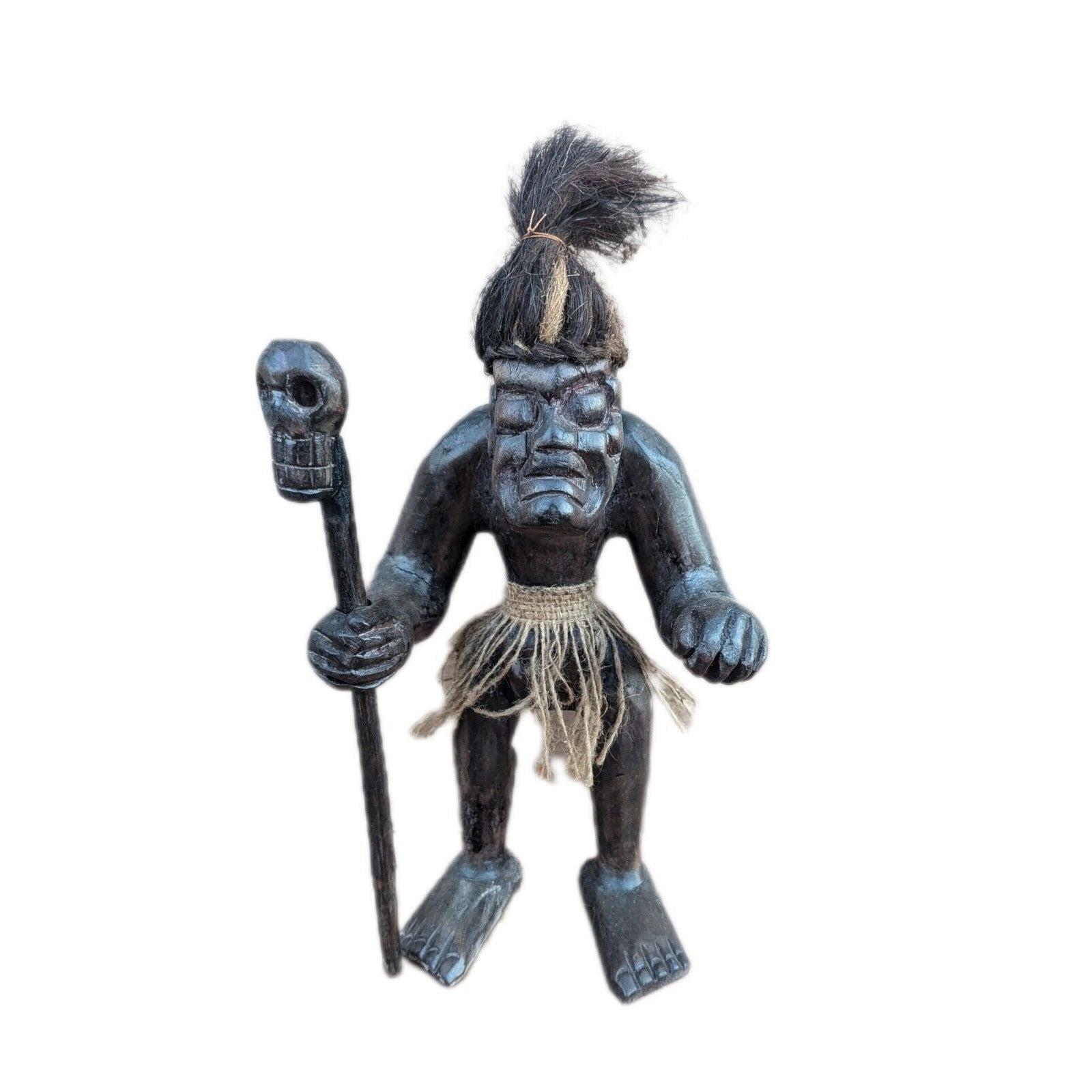 Blue-black wooden tiki statue with a staff and a fiber skirt