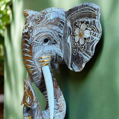 Decorative carved elephant head sculpture with floral patterns