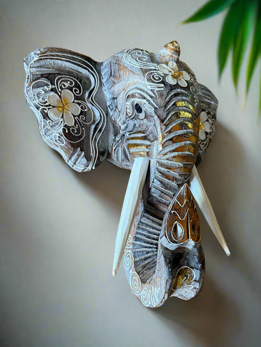 Decorative elephant head sculpture with floral patterns and gold accents