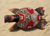 decorative mosaic turtle sculpture with shell-inlay patterns on sandy beach