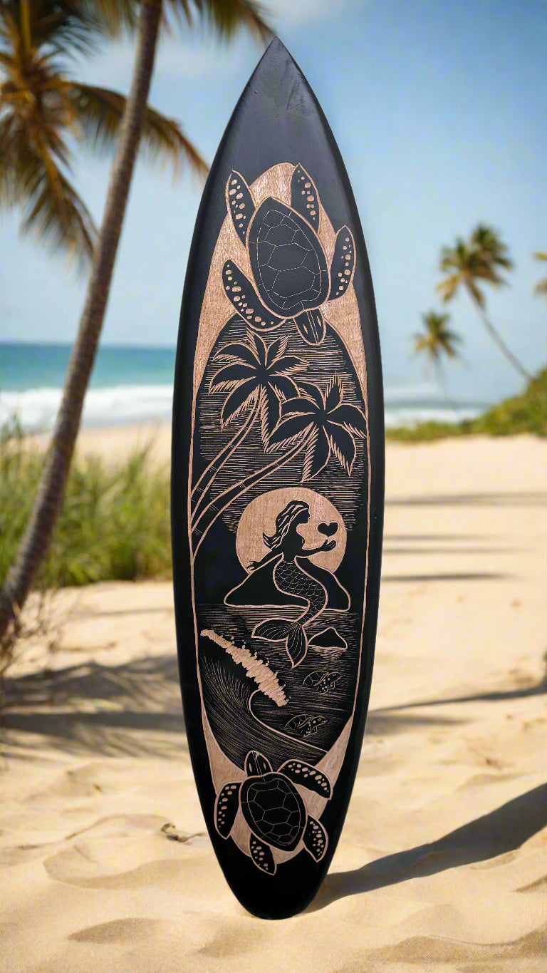Decorative surfboard featuring a mermaid, sea turtle, and palm trees on a sunny beach