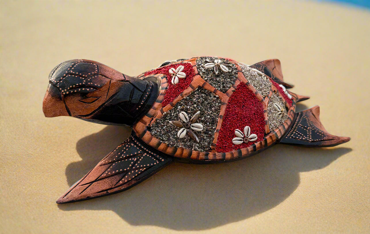 Decorative turtle sculpture with beaded shell and red-gray geometric pattern