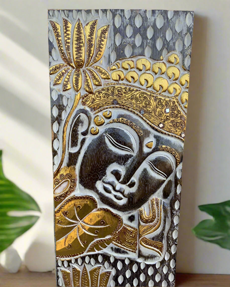 Vertical Buddha head relief on a decorative panel with gold accents and intricate patterns.