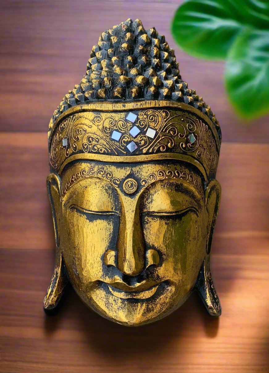 Gold Buddha head statue with ornate headband and mosaic inlays