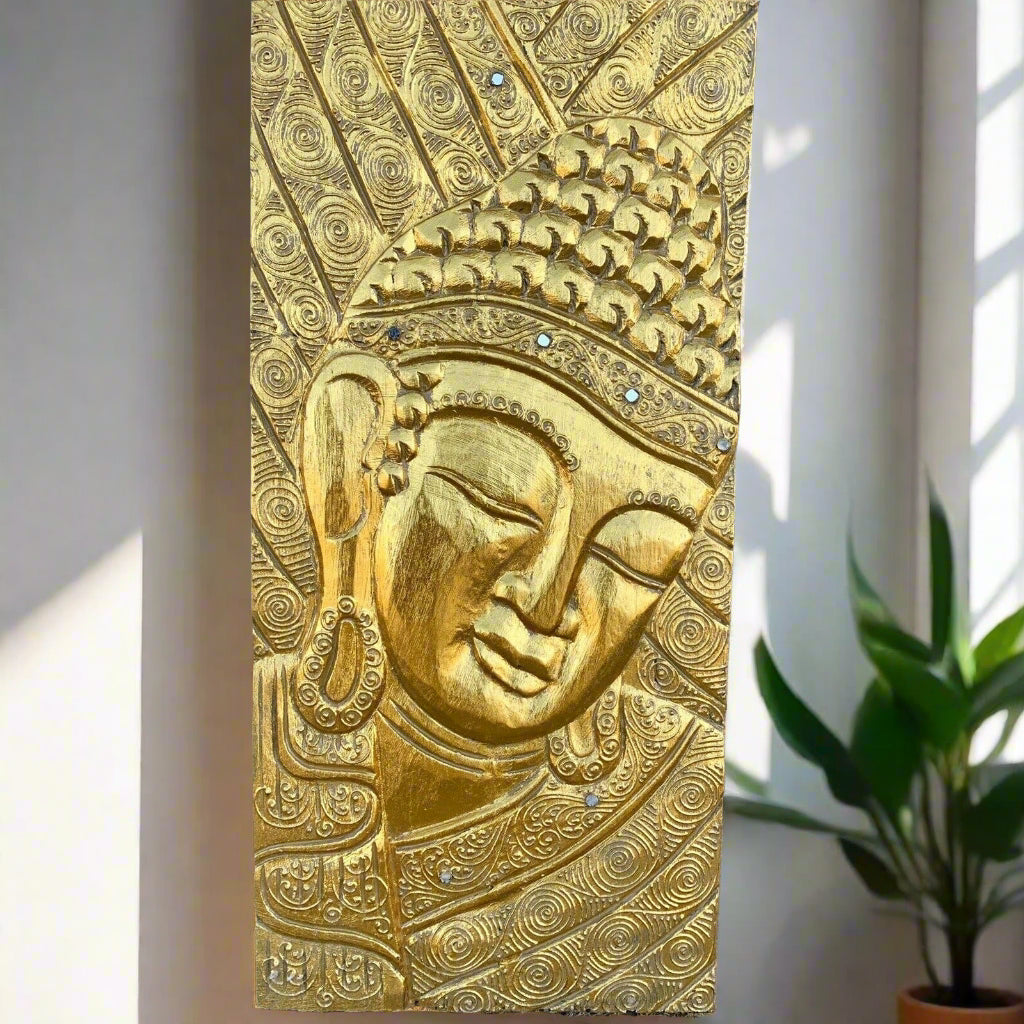golden Buddha head relief panel with intricate swirling patterns and gem accents