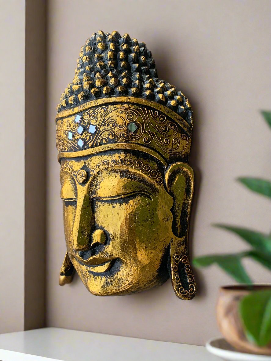 Golden Buddha head wall sculpture with ornate patterns and blue gem accents