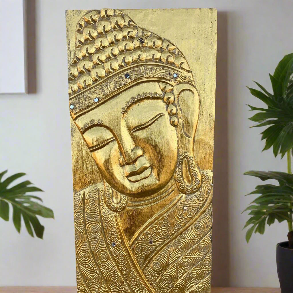 golden Buddha head relief on ornate carved wooden panel with swirling patterns