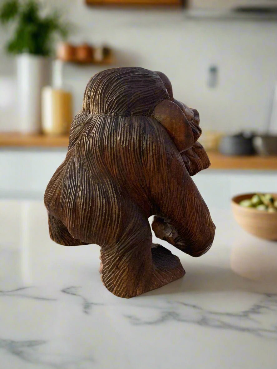 Dark brown gorilla bust sculpture with textured fur on a kitchen counter.