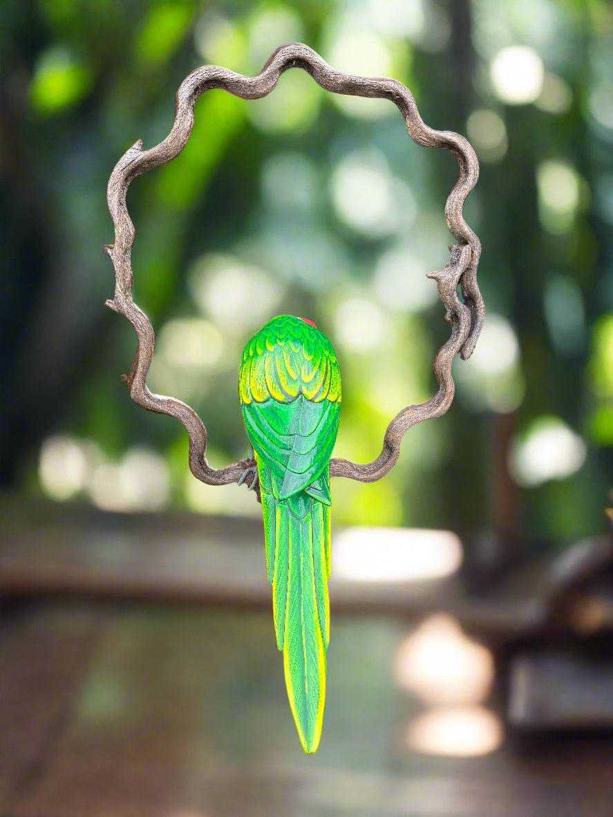 Green parrot perched on a curly twisted branch ring in a garden