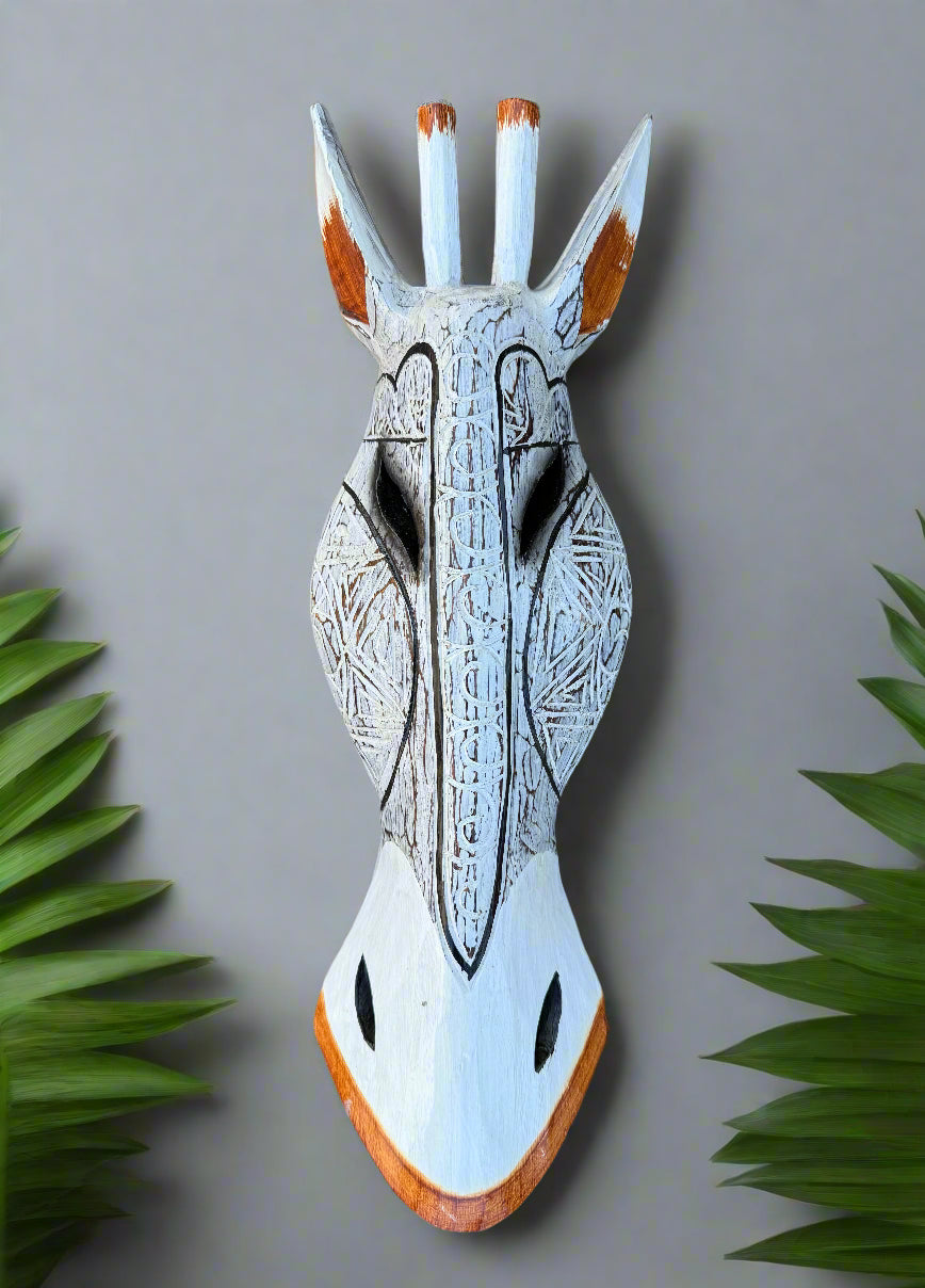 Hand-carved wooden horse head mask with tribal engravings and orange-tipped ears