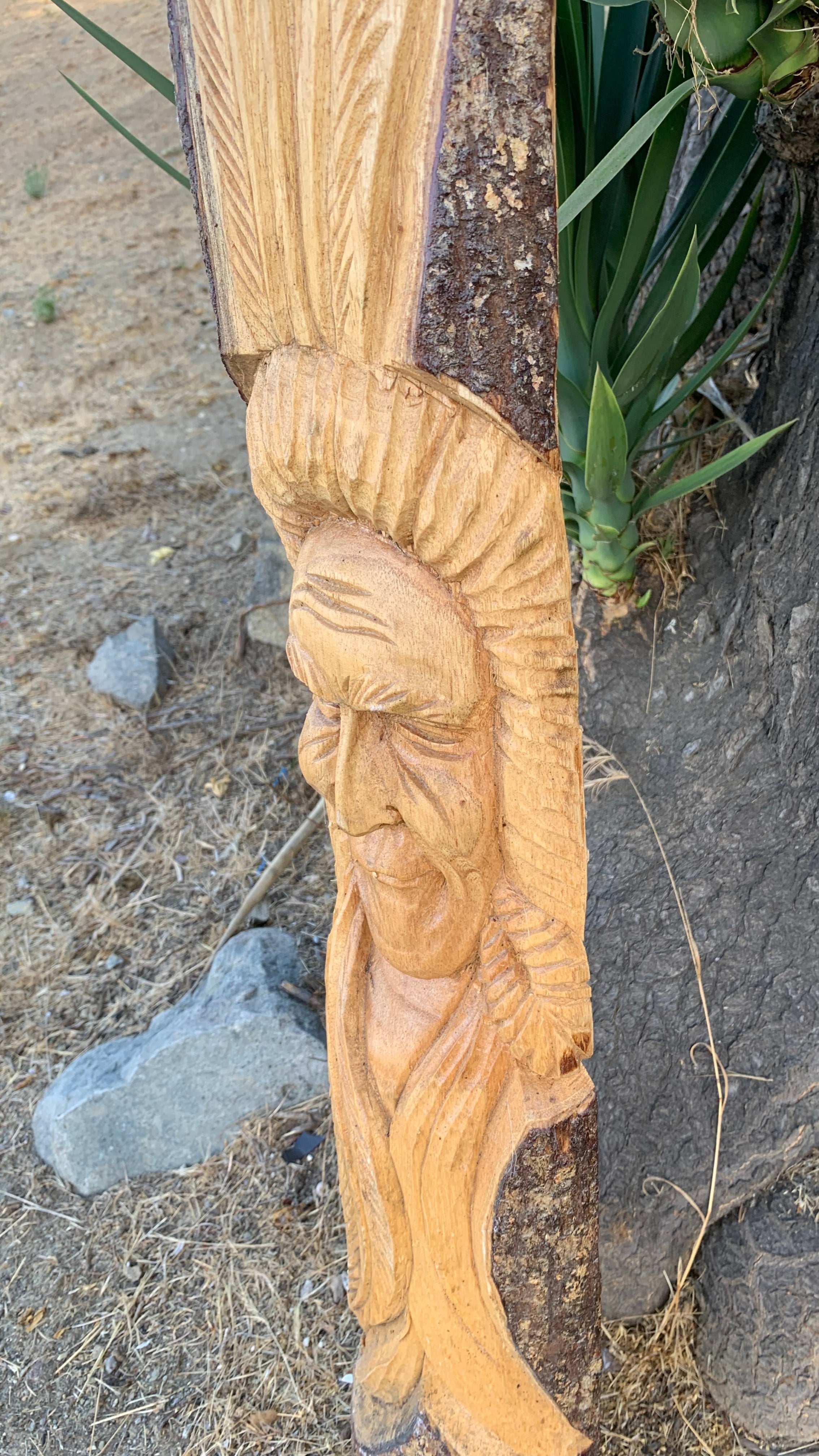 carved-wooden-face-of-elderly-man-with-flowing-hair