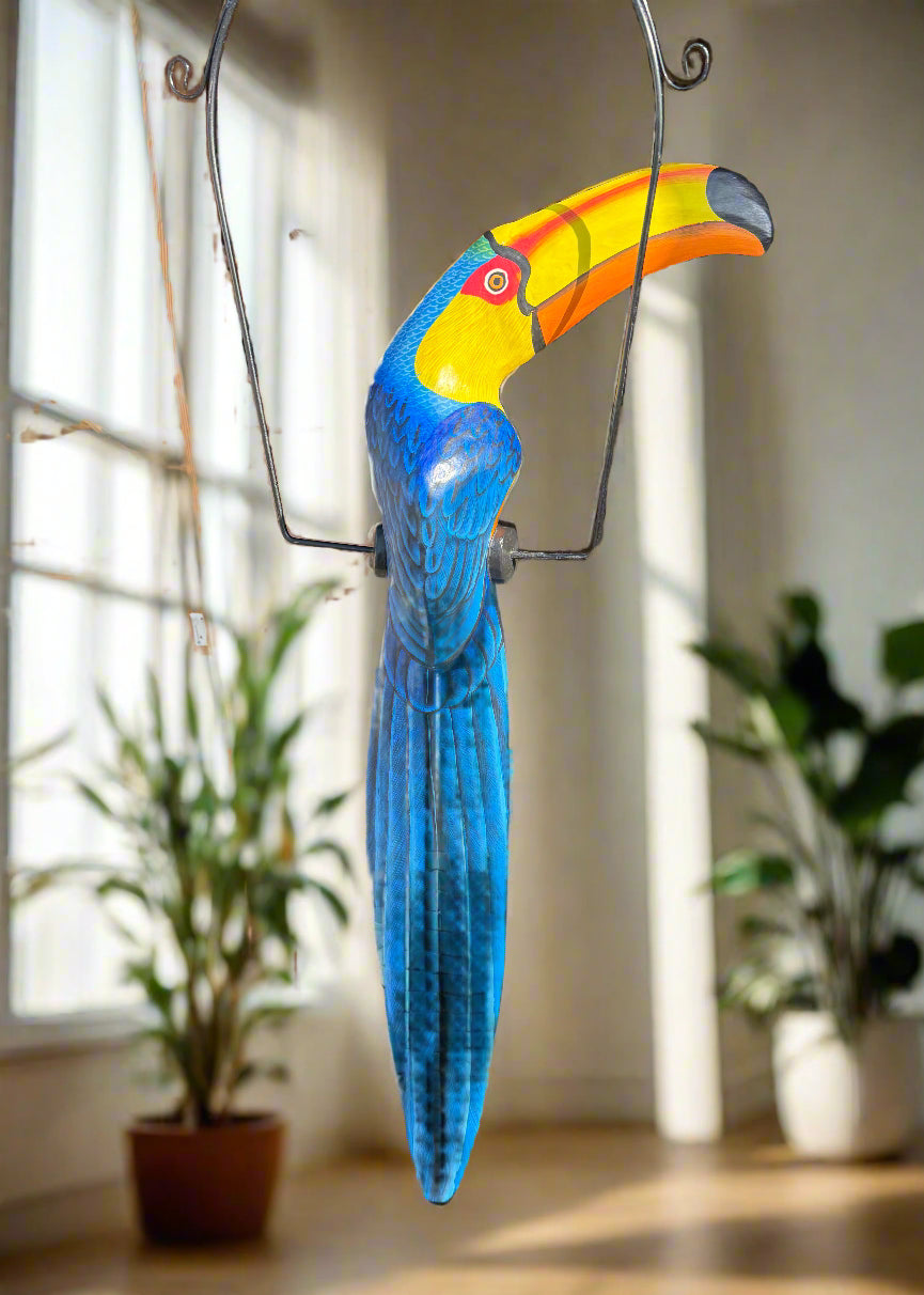 Colorful blue and yellow toucan wall sculpture hanging indoors
