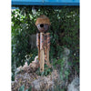 handmade bamboo wind chime with carved patterns hanging outdoors